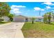 Charming single-story home featuring a well-maintained lawn, palm trees, and a welcoming facade at 11237 Sw 78Th Ct, Ocala, FL 34476