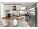Kitchen boasts breakfast bar with seating and view into living room and stainless appliances at 11237 Sw 78Th Ct, Ocala, FL 34476