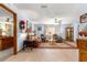 Living room with wood-look floors, ceiling fan, and comfortable seating by the window at 11237 Sw 78Th Ct, Ocala, FL 34476