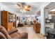 Open concept living room with ceiling fans, wood floors, and a view to the kitchen at 11237 Sw 78Th Ct, Ocala, FL 34476