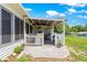 Enjoy outdoor living on this brick patio with a white picket fence and a covered awning for shade at 11237 Sw 78Th Ct, Ocala, FL 34476