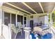 The covered patio with outdoor furniture and a grill offers a perfect space for entertaining or relaxing outdoors at 11237 Sw 78Th Ct, Ocala, FL 34476