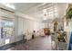This light-filled sunroom features neutral decor, large windows, and tile floors creating a relaxing and inviting atmosphere at 11237 Sw 78Th Ct, Ocala, FL 34476