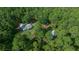 Aerial view showcases homes nestled within a lush, dense forest, providing a private and serene setting at 11521 Se 1St Street Rd, Silver Springs, FL 34488