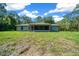 Backyard view of the home with screened in porch and lots of land at 11521 Se 1St Street Rd, Silver Springs, FL 34488