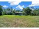 Rear exterior of the house with screened porch and large lawn at 11521 Se 1St Street Rd, Silver Springs, FL 34488