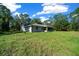 Backyard view of the home with a pavilion and lots of land at 11521 Se 1St Street Rd, Silver Springs, FL 34488