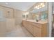 Bright bathroom with a double sink vanity, tile flooring, and a glass-enclosed shower at 11521 Se 1St Street Rd, Silver Springs, FL 34488