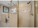 Bathroom featuring a walk-in shower with glass enclosure and a separate toilet area at 11521 Se 1St Street Rd, Silver Springs, FL 34488