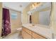 Bathroom with a vanity, mirror, and a shower-tub combination, providing essential amenities at 11521 Se 1St Street Rd, Silver Springs, FL 34488