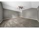 Large bedroom with neutral gray walls, vaulted ceilings, carpet, and a ceiling fan at 11521 Se 1St Street Rd, Silver Springs, FL 34488