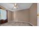 Bedroom with carpeted floors, ceiling fan, and window, offering a comfortable living space at 11521 Se 1St Street Rd, Silver Springs, FL 34488