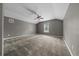 Spacious bedroom with vaulted ceilings, neutral walls, carpet, ceiling fan, and a window at 11521 Se 1St Street Rd, Silver Springs, FL 34488