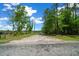 Long driveway with tree lined entrance leading to the property at 11521 Se 1St Street Rd, Silver Springs, FL 34488