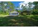 View of the detached garage and equipment storage building. Basketball hoop on the side at 11521 Se 1St Street Rd, Silver Springs, FL 34488