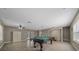 Angle view of the game room featuring a pool table, tile flooring, fan, and neutral paint at 11521 Se 1St Street Rd, Silver Springs, FL 34488