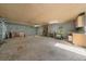 Oversized garage space featuring exposed brick walls, built-in cabinets, and fluorescent lighting at 11521 Se 1St Street Rd, Silver Springs, FL 34488
