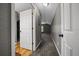 Upstairs hallway featuring gray walls, neutral carpet, and white trim doors at 11521 Se 1St Street Rd, Silver Springs, FL 34488