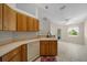 Bright kitchen featuring tile floors, wood cabinets, and modern appliances, ideal for cooking and dining at 11521 Se 1St Street Rd, Silver Springs, FL 34488