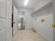 Functional laundry room with tile flooring, shelving, and essential laundry connections at 11521 Se 1St Street Rd, Silver Springs, FL 34488