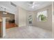 Open living area with tile flooring, patio access, ceiling fan, and natural light at 11521 Se 1St Street Rd, Silver Springs, FL 34488