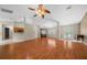 Open living area with wood floors, bright lighting, and view of the kitchen at 11521 Se 1St Street Rd, Silver Springs, FL 34488