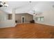 Spacious living room featuring vaulted ceilings, laminate flooring, and neutral paint at 11521 Se 1St Street Rd, Silver Springs, FL 34488