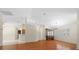 Open concept living room with wood flooring, neutral paint, and bright lighting at 11521 Se 1St Street Rd, Silver Springs, FL 34488