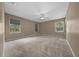 Spacious primary bedroom with ample natural light and neutral carpet at 11521 Se 1St Street Rd, Silver Springs, FL 34488