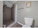 Bathroom with a tiled stand-up shower, bronze hardware and adjacent toilet at 11521 Se 1St Street Rd, Silver Springs, FL 34488