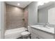 Bathroom featuring a modern vanity, bathtub with tile surround, and a convenient shower head at 12472 Se 67Th Terrace Rd, Belleview, FL 34420