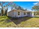 Charming gray home featuring well-maintained landscaping, a one car garage, and a welcoming entrance at 12472 Se 67Th Terrace Rd, Belleview, FL 34420
