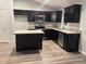 This kitchen features dark wood cabinets, stainless steel appliances, and granite countertops at 12472 Se 67Th Terrace Rd, Belleview, FL 34420
