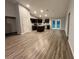 An open-concept kitchen features dark cabinets, stainless steel appliances, and a center island at 12472 Se 67Th Terrace Rd, Belleview, FL 34420