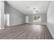 Expansive living room with neutral walls, vaulted ceilings, and ample natural light from a large window at 12472 Se 67Th Terrace Rd, Belleview, FL 34420