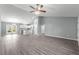 Spacious open-concept living area with high ceilings and contemporary flooring, leading into kitchen at 12472 Se 67Th Terrace Rd, Belleview, FL 34420