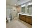 Bathroom featuring a double sink vanity and glass door shower with decorative tile at 13303 Sw 106Th Pl, Dunnellon, FL 34432