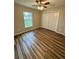 Bedroom features wood-look flooring, closet, and a window at 13303 Sw 106Th Pl, Dunnellon, FL 34432