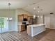Bright, open concept kitchen features stainless appliances, a center island, and adjacent dining area at 13303 Sw 106Th Pl, Dunnellon, FL 34432