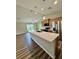 Open kitchen features a large island with granite countertops, modern appliances and a view to living area at 13303 Sw 106Th Pl, Dunnellon, FL 34432