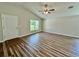 Spacious living room featuring a ceiling fan, wood-look flooring and a large window for natural light at 13303 Sw 106Th Pl, Dunnellon, FL 34432