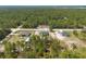 Overview of multiple homes in a rural neighborhood surrounded by trees and green landscapes at 13561 Sw 85Th Pl, Dunnellon, FL 34432