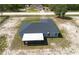 Back aerial showcasing a screened porch with a spacious yard on a well-maintained home at 13561 Sw 85Th Pl, Dunnellon, FL 34432
