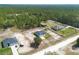 Overview of multiple homes in a rural neighborhood surrounded by trees and green landscapes at 13561 Sw 85Th Pl, Dunnellon, FL 34432