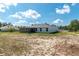 View of the home's back yard, home's screened porch, and neighboring homes at 13561 Sw 85Th Pl, Dunnellon, FL 34432