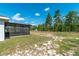 The large backyard and screened-in porch are visible in this shot of the back of the home at 13561 Sw 85Th Pl, Dunnellon, FL 34432