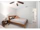 Cozy bedroom with a ceiling fan and a wooden bed frame at 13561 Sw 85Th Pl, Dunnellon, FL 34432