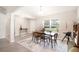 Bright dining room featuring a wooden table, a large window with natural light, and light-colored flooring at 13561 Sw 85Th Pl, Dunnellon, FL 34432