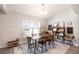 Airy dining area showcasing a wooden table and chairs, complemented by modern décor and natural lighting at 13561 Sw 85Th Pl, Dunnellon, FL 34432