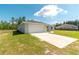 Beautifully landscaped front yard leading up to a well-maintained home with an attached two-car garage at 13561 Sw 85Th Pl, Dunnellon, FL 34432